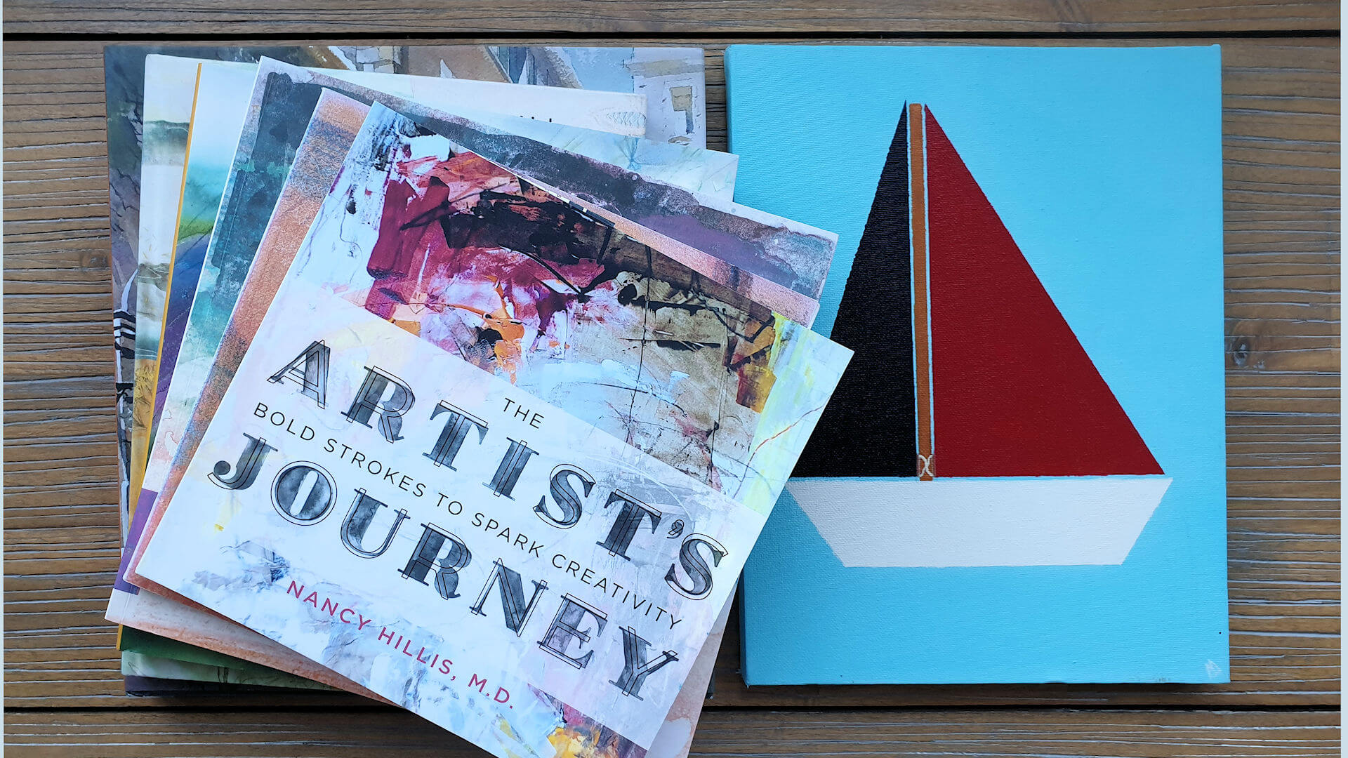 The Artists Journey book and a painting of a sailing boat by my friend